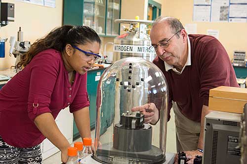 engineering professor Otto Gregory and student working in the lab