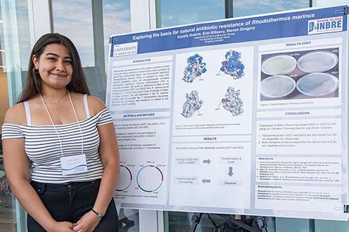 Kamila Guerra presents her research poster at the RI Summer Research Symposium