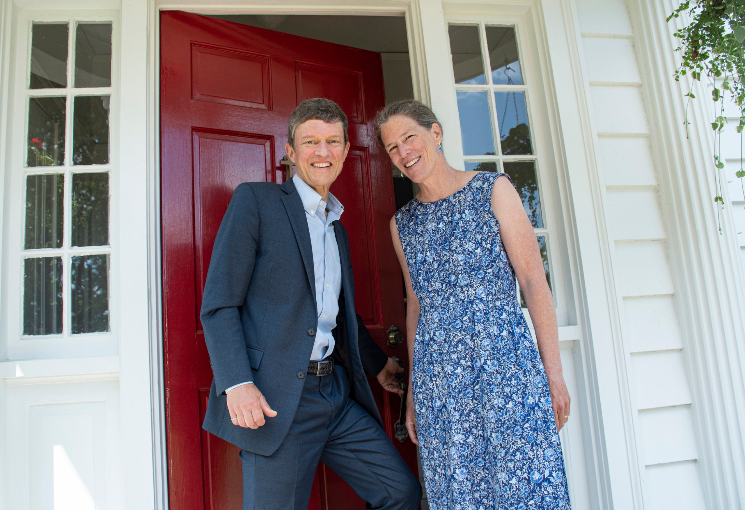 Mary and Marc Parlange stand in the doorway of their campus home