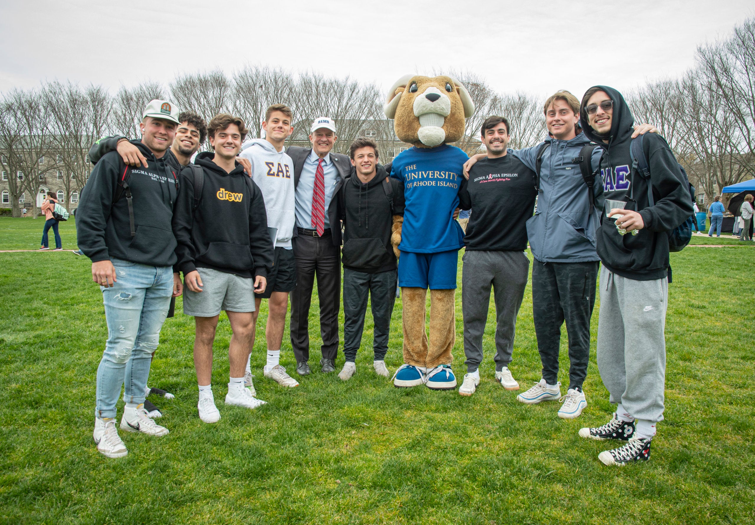 President Marc Parlange poses with Rhody the Ram and students on the Quad on the last day of class, 2022