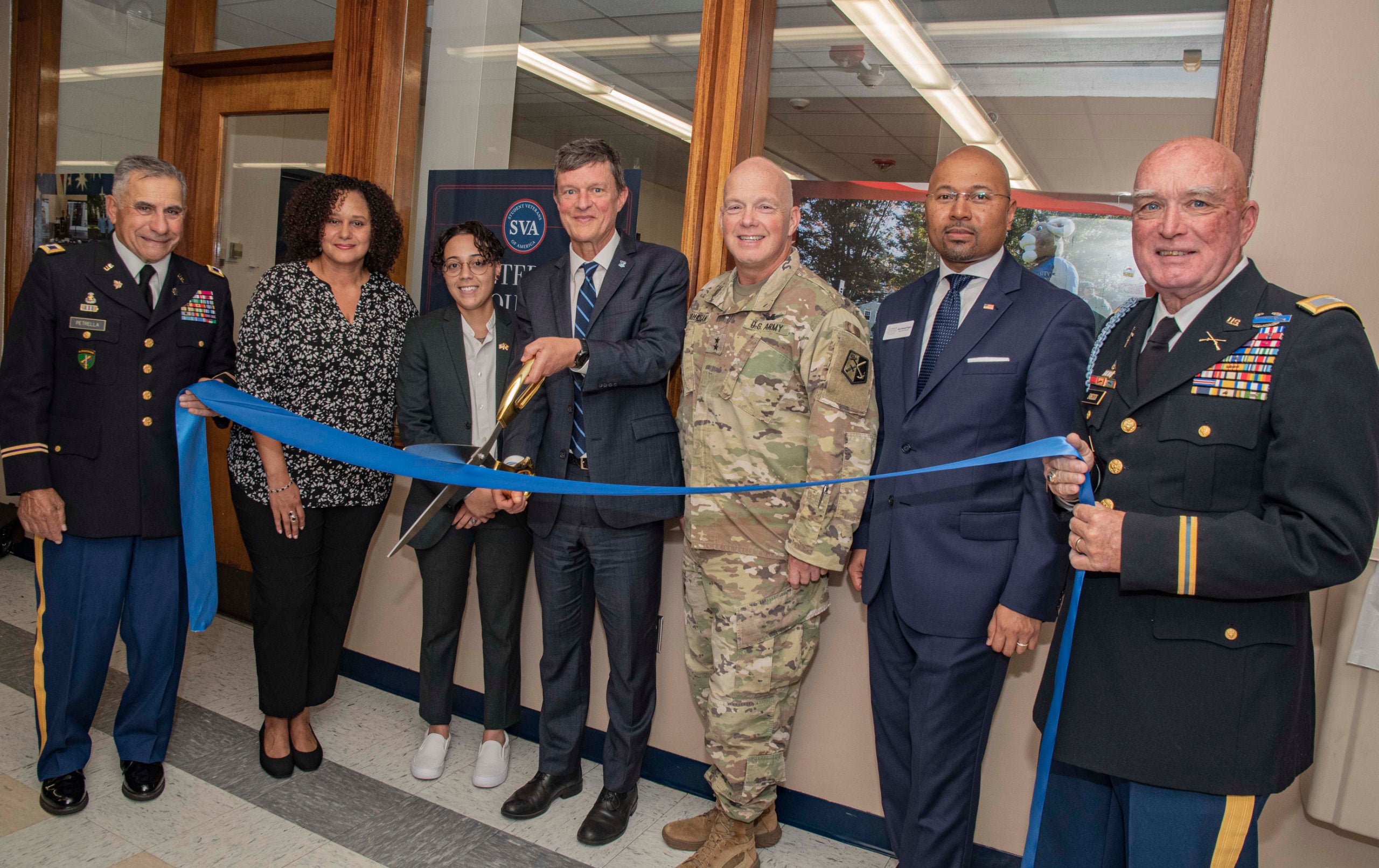 President Parlange at a ribbon cutting ceremony, surrounded by retired members of the U.S. military and URI leadership