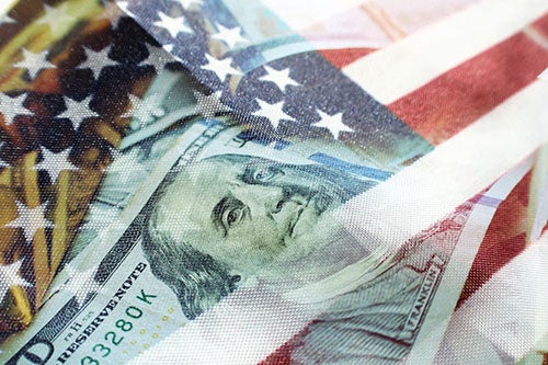stock photo ofAmerican Flag insert of $100 bill