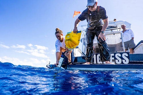 Christine De Silva retrieving underwater camera