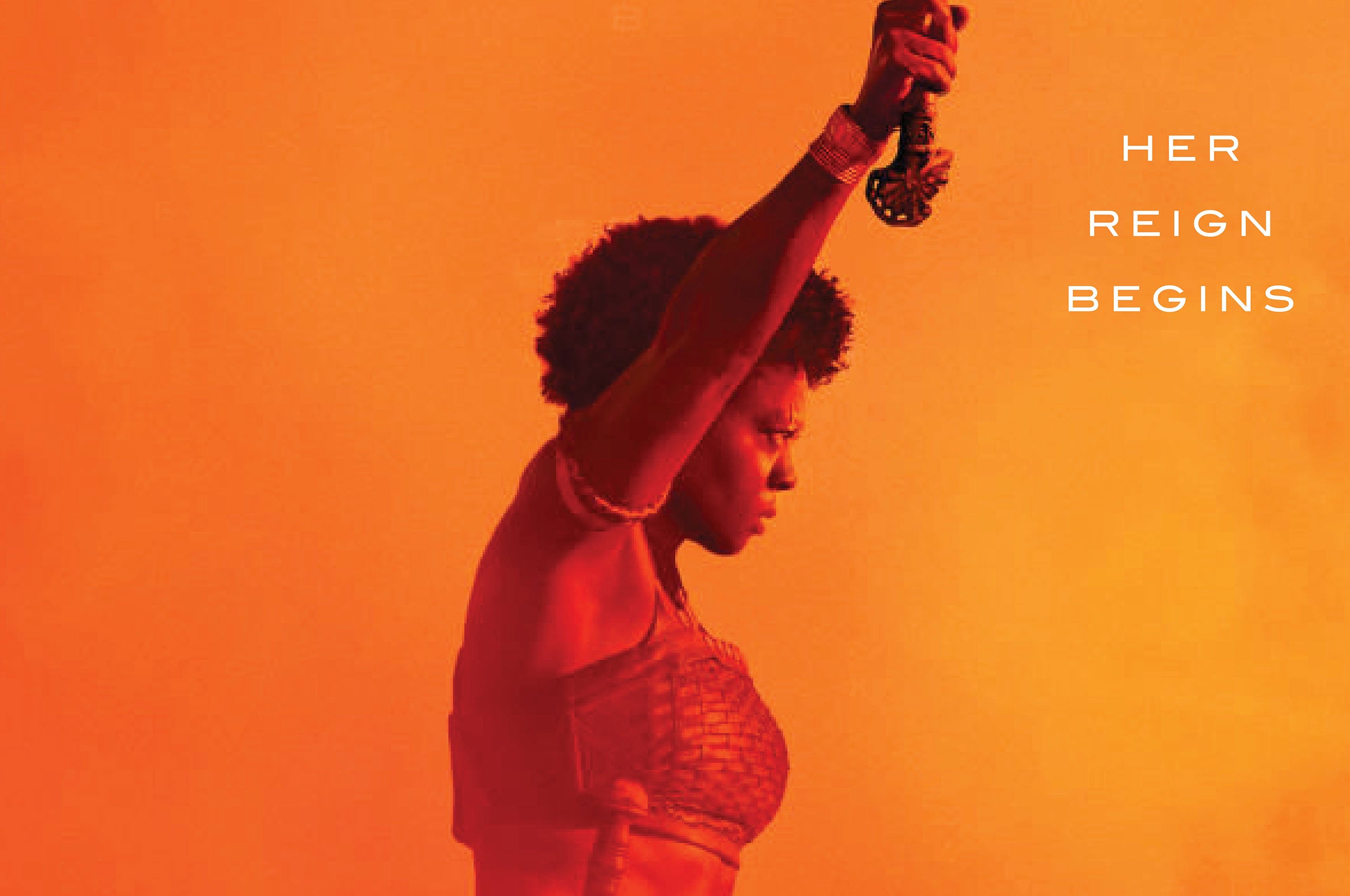 triumphant image of a woman from the film The Woman King with the words Her Reign Begins