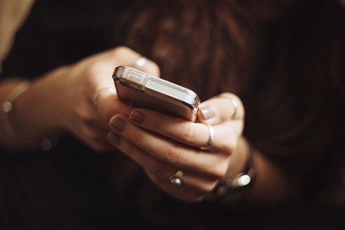 hands holding mobile phone