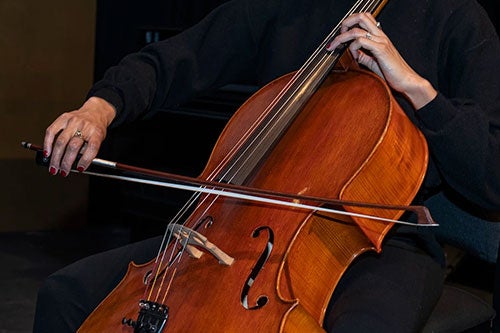 woman hands playing the cello