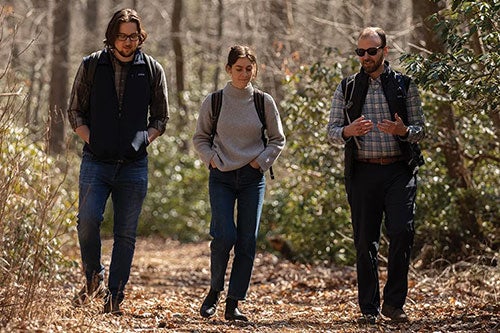 Graduate student Joe Ahart, research assistant Ally Overbay and Dr. Madison Jones, assistant professor of Writing and Rhetoric and Natural Resources Science, in the North Woods near the URI campus.