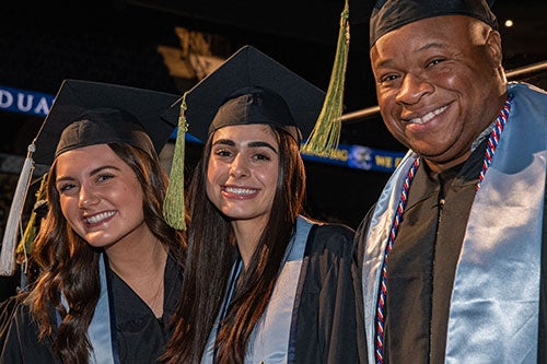 Three graduates at the Fall 2023 Commencement ceremony