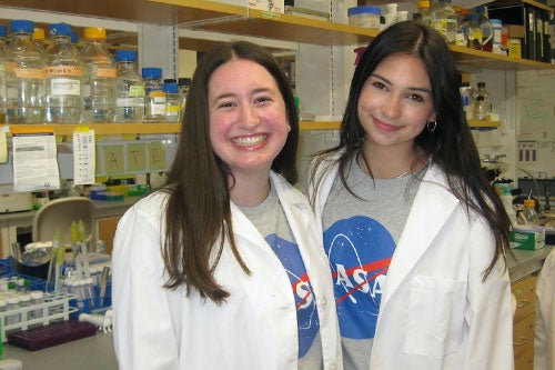 Ph.D. students and NASA graduate research fellowships Michelle Marden and Kate Remy in the lab