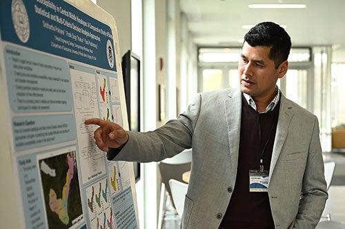 Graduate student explaining his research